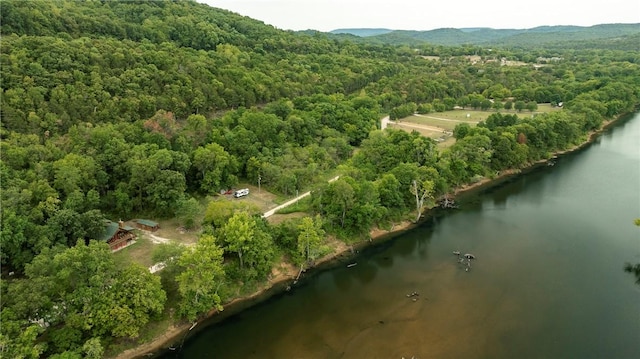 aerial view featuring a view of trees and a water view