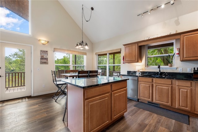 kitchen featuring high vaulted ceiling, an inviting chandelier, stainless steel dishwasher, dark hardwood / wood-style floors, and a kitchen island