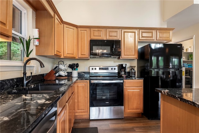 kitchen with dark stone countertops, sink, black appliances, and dark hardwood / wood-style flooring