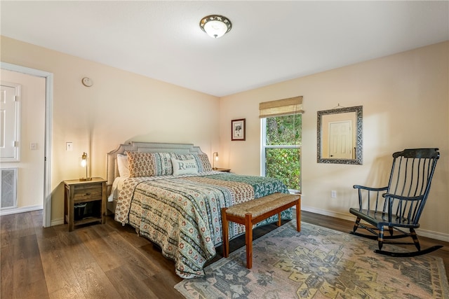 bedroom with dark hardwood / wood-style flooring