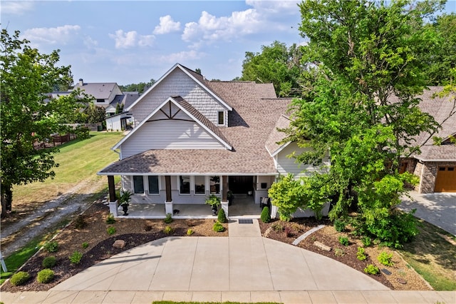 view of front of property with a porch and a garage