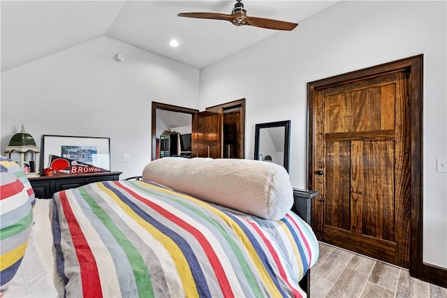 bedroom with vaulted ceiling, ceiling fan, and light wood-type flooring