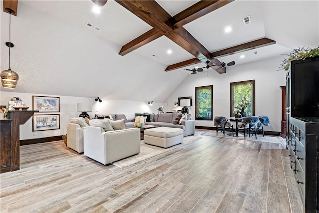 living room with lofted ceiling with beams and light hardwood / wood-style flooring