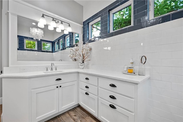 bathroom featuring vanity, wood-type flooring, and an inviting chandelier