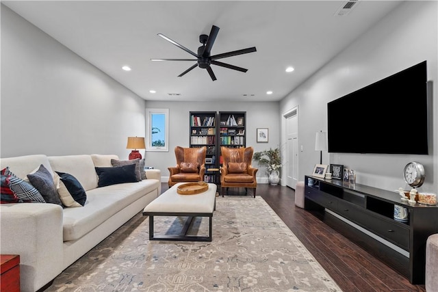 living room with dark hardwood / wood-style flooring and ceiling fan