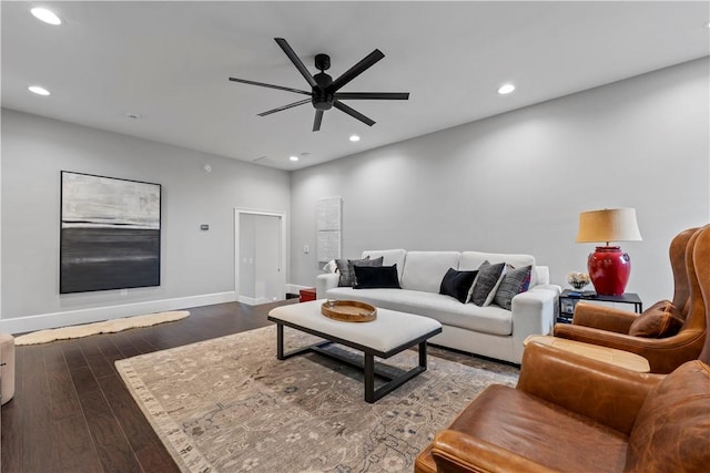 living room with ceiling fan and dark hardwood / wood-style floors