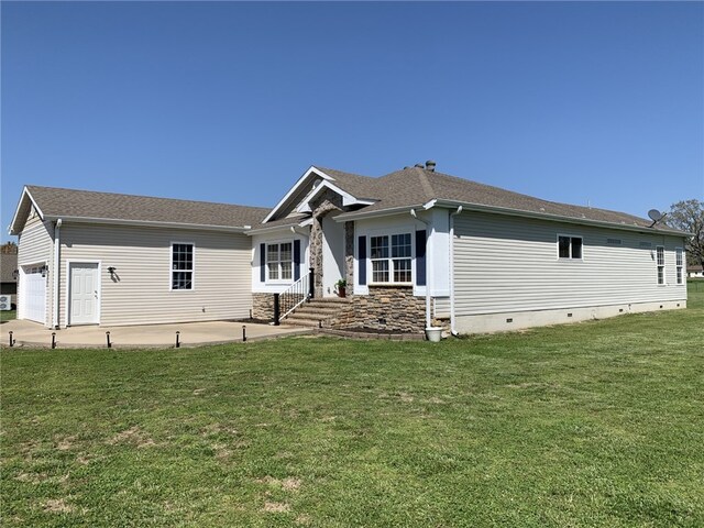 view of front of house with a front yard, a patio area, a garage, and crawl space