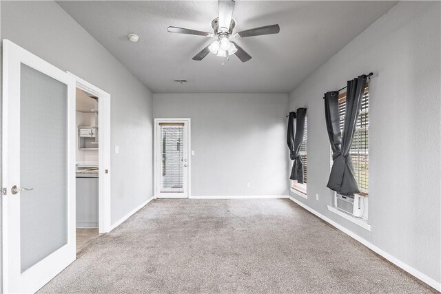 empty room with baseboards, a ceiling fan, and carpet flooring
