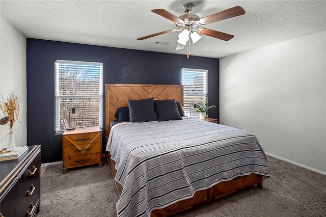 carpeted bedroom featuring a textured ceiling, ceiling fan, and multiple windows