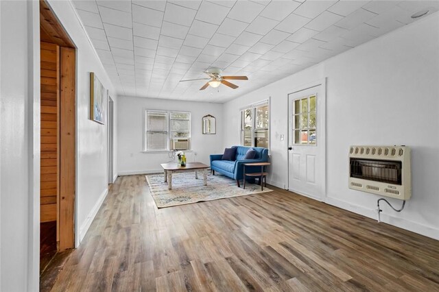 156 Main, Colcord, OK 74338 - sitting room with heating unit, wood finished floors, a ceiling fan, and baseboards