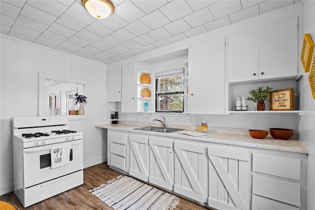 kitchen featuring dark wood-type flooring, white cabinets, sink, and white gas range