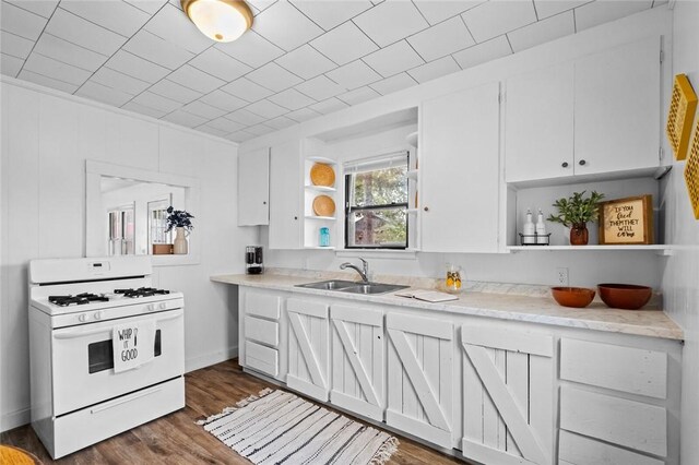 156 Main, Colcord, OK 74338 - kitchen with white gas stove, open shelves, a sink, white cabinetry, and light countertops