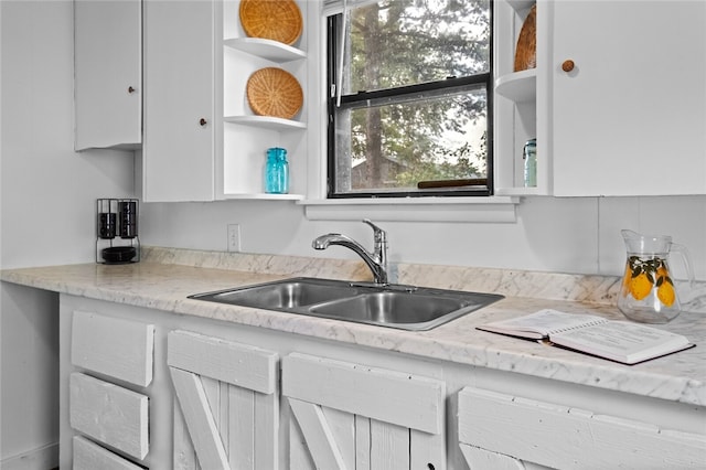 kitchen with sink and light stone counters