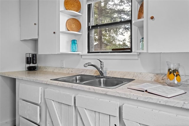 156 Main, Colcord, OK 74338 - kitchen with a sink, white cabinets, open shelves, and light stone counters