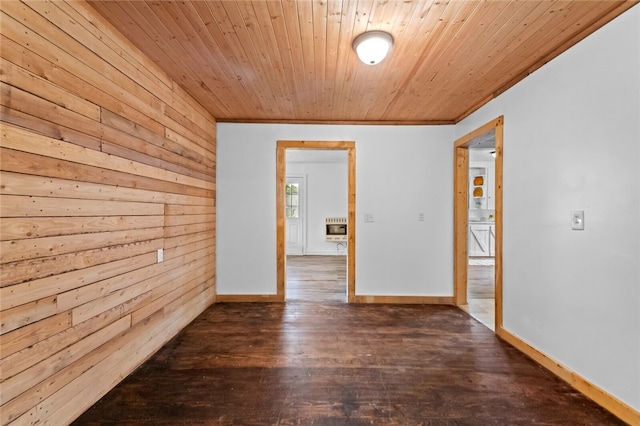 spare room with wood walls, hardwood / wood-style floors, and wood ceiling