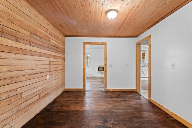 156 Main, Colcord, OK 74338 - spare room with heating unit, wood finished floors, wood walls, wood ceiling, and crown molding