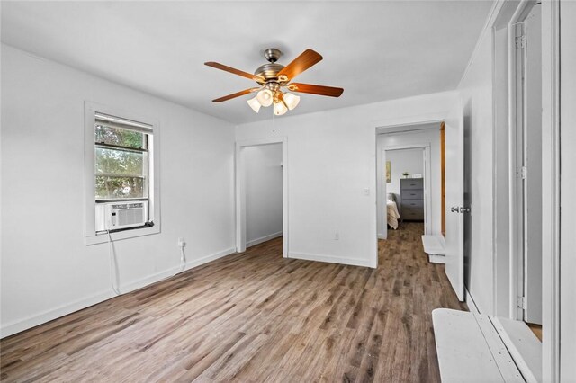 156 Main, Colcord, OK 74338 - unfurnished bedroom with wood finished floors, baseboards, cooling unit, and ceiling fan
