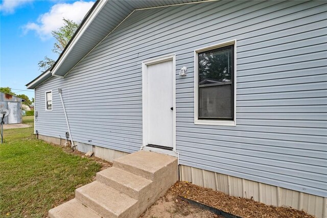 156 Main, Colcord, OK 74338 - doorway to property featuring a yard