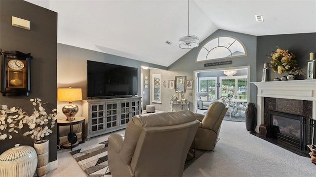 living room with visible vents, a high end fireplace, vaulted ceiling, and light colored carpet