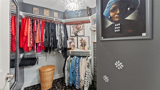 walk in closet with an inviting chandelier