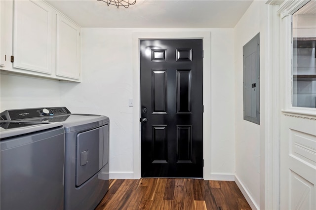 laundry room with cabinet space, dark wood-type flooring, washing machine and dryer, electric panel, and baseboards