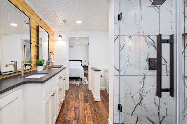 ensuite bathroom featuring visible vents, wood ceiling, wood finished floors, ensuite bathroom, and vanity