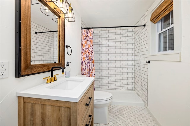 bathroom with toilet, a shower stall, and vanity