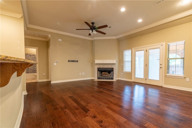 unfurnished living room featuring ceiling fan, crown molding, a fireplace, and hardwood / wood-style flooring