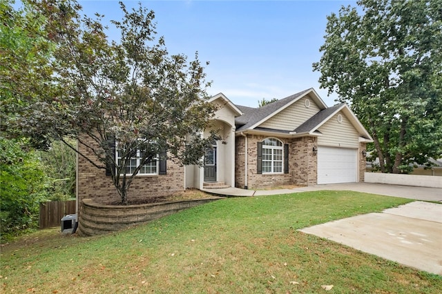 view of front of home with a garage and a front lawn