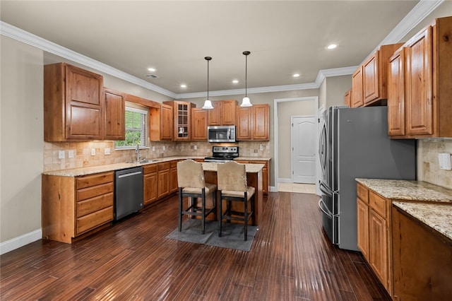 kitchen with backsplash, dark hardwood / wood-style floors, stainless steel appliances, and a center island