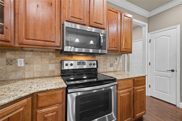 kitchen featuring decorative backsplash, light stone counters, appliances with stainless steel finishes, crown molding, and dark wood-type flooring