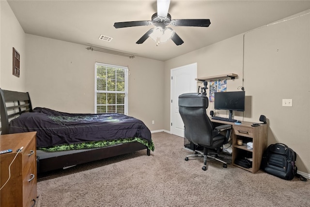 bedroom with ceiling fan and light carpet