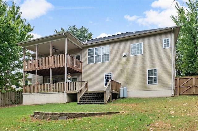 rear view of house with a yard and a deck