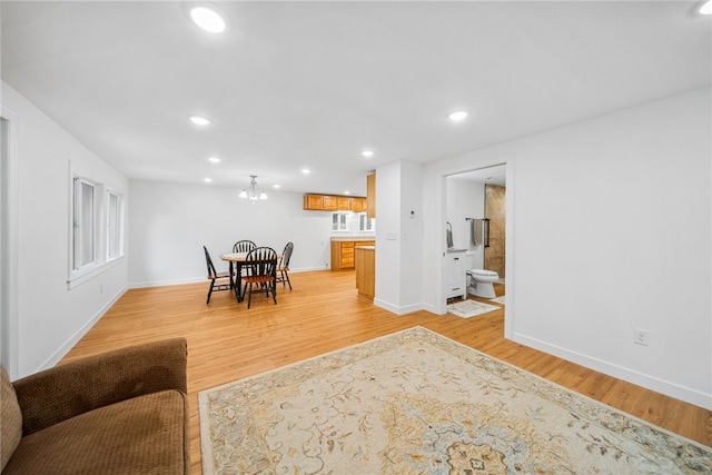 dining room with a chandelier and light wood-type flooring