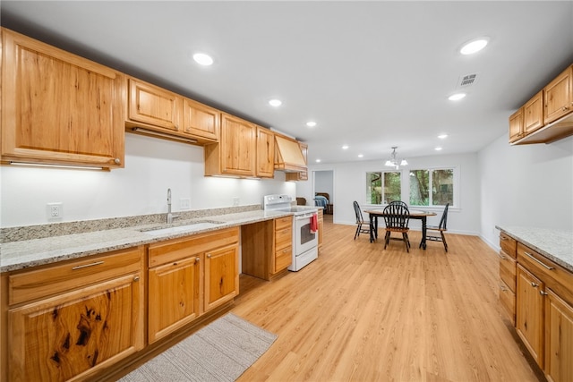 kitchen with light stone countertops, sink, white electric range oven, a notable chandelier, and light wood-type flooring