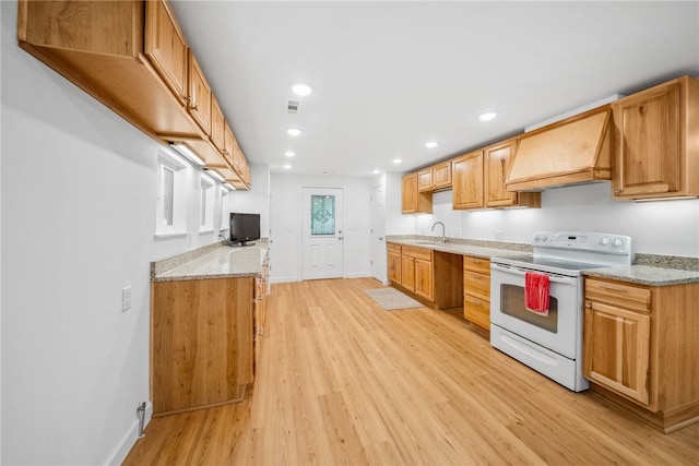 kitchen featuring white electric range oven, light stone countertops, light wood-type flooring, and custom range hood