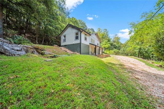 view of side of property with a lawn