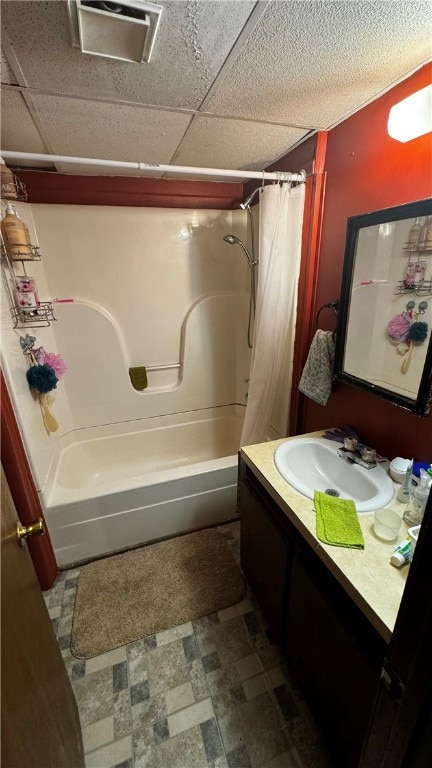 bathroom featuring tile patterned floors, shower / tub combo, a paneled ceiling, and vanity