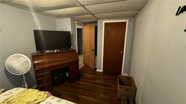 bedroom featuring dark hardwood / wood-style floors and a drop ceiling