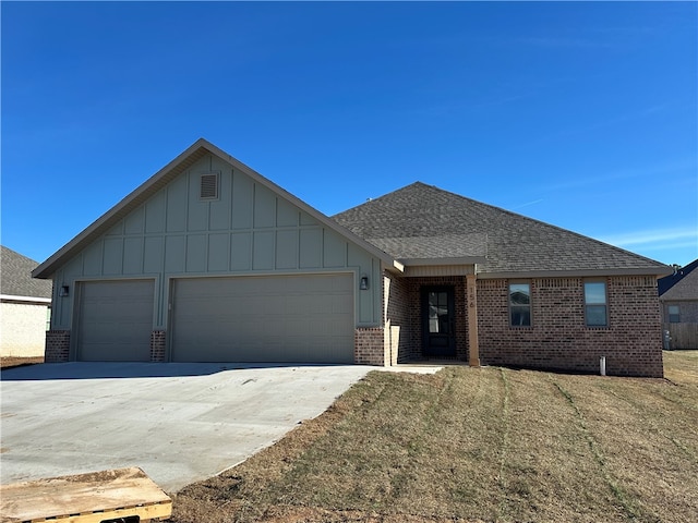 view of front facade with a garage and a front lawn