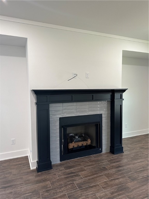 interior details with a tiled fireplace and hardwood / wood-style floors