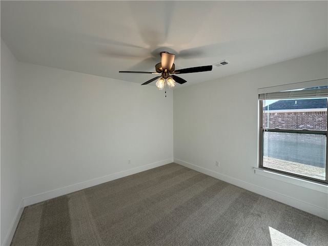 spare room featuring ceiling fan and carpet floors