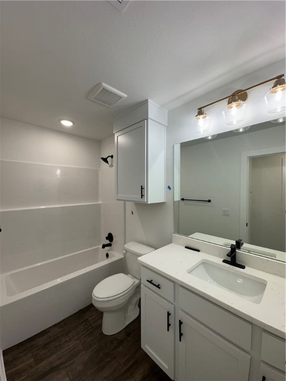 full bathroom featuring vanity, hardwood / wood-style flooring, toilet, and shower / bathtub combination