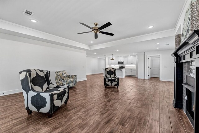 living area with visible vents, dark wood finished floors, recessed lighting, a fireplace, and ceiling fan