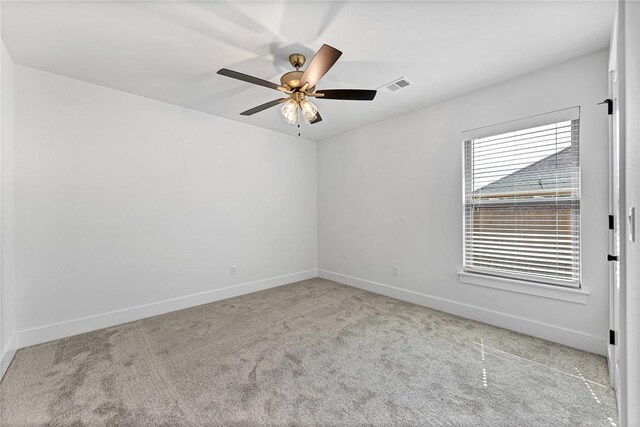 unfurnished room with visible vents, a ceiling fan, baseboards, and carpet floors