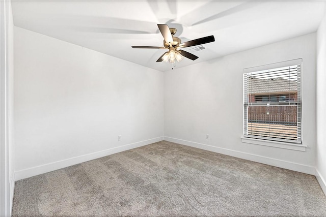 carpeted empty room with visible vents, baseboards, and ceiling fan