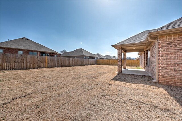 view of yard with a patio and a fenced backyard