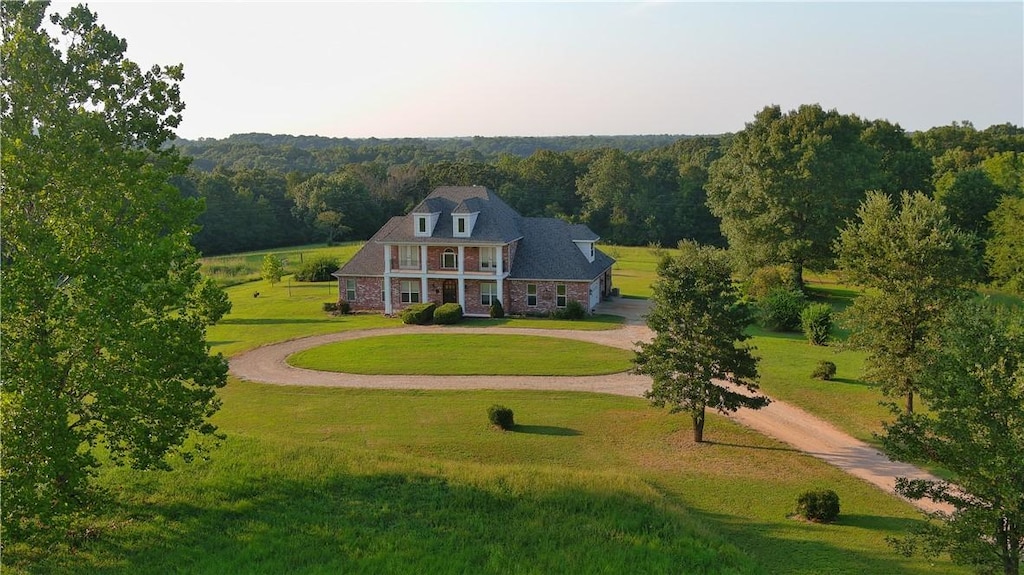 drone / aerial view featuring a forest view