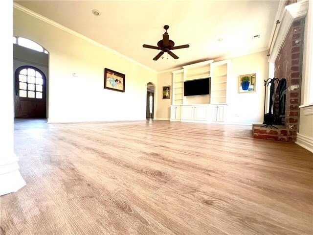 unfurnished living room featuring light hardwood / wood-style floors, ornamental molding, ceiling fan, and built in shelves