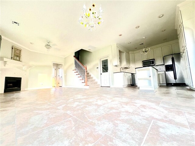 interior space featuring ornamental molding, ceiling fan with notable chandelier, and light tile patterned floors